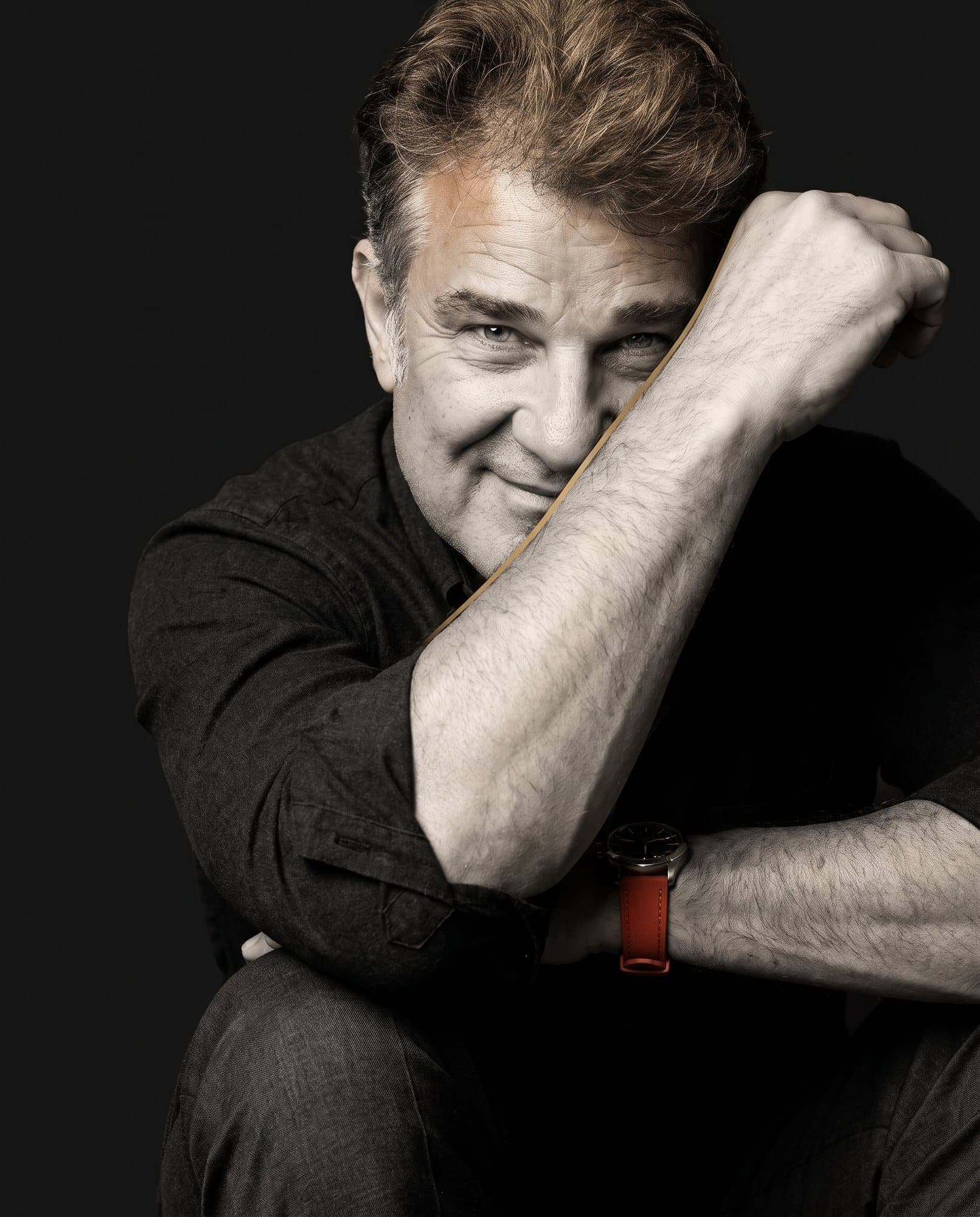 Daniel Santos Cori seated in a dark studio